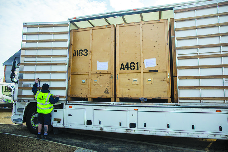 Wooden storage crates about to be unloaded from a Britannia Alan Cook Removals & Storage lorry at a customers new home