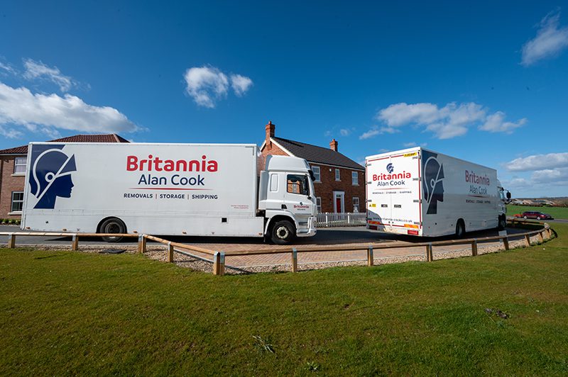 Britannia Alan Cook Removals & Storage lorries outside a customers new home ready to be unloaded