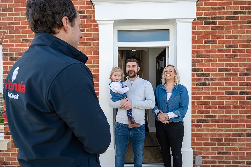 Britannia Alan Cook Removals & Storage removals manager being greeted by a happy couple and their young daughter