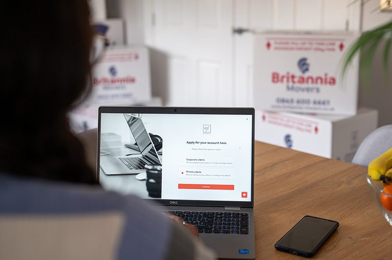 Britannia Alan Cook 8955 Young woman looking at the website of Britannia Alan Cook Removals & Storage foreign exchange partners, IFX a leading foreign exchange and payments consultancy