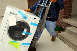 A washing machine being delivered using a special trolley capable of navigating steeps