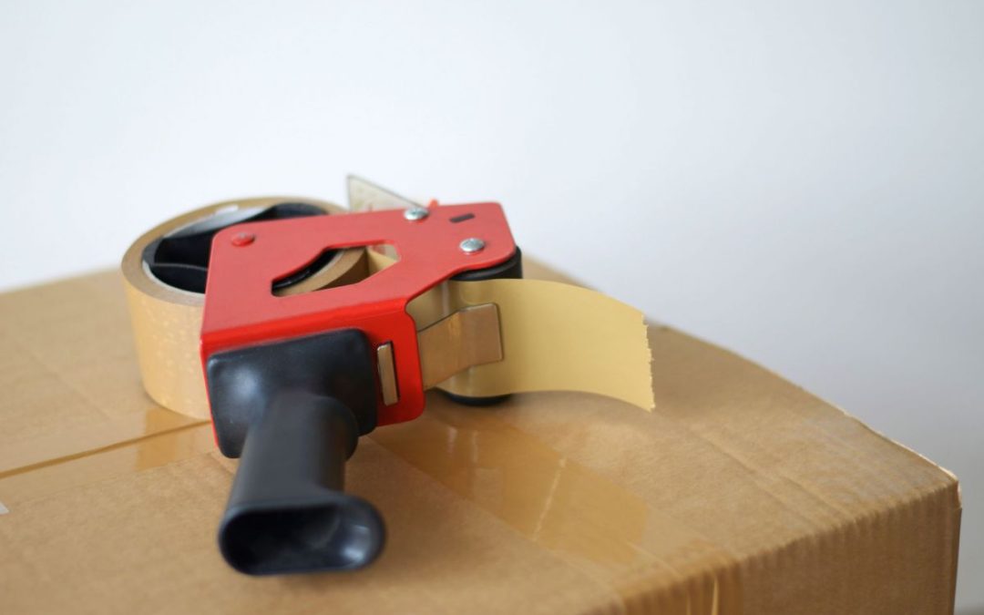 A handy packing tape gun on top of a box ready for loading onto a removals lorry