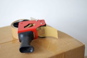 A handy packing tape gun on top of a box ready for loading onto a removals lorry