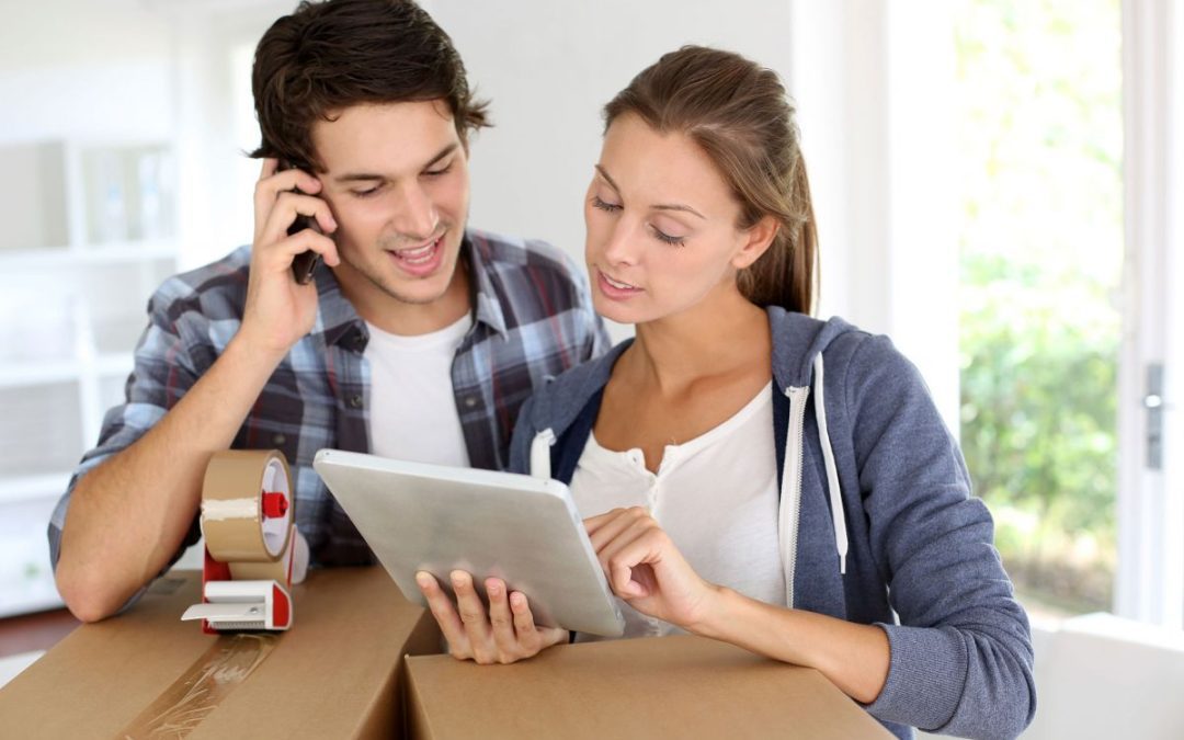 A couple checking our details on a tablet and talking on a mobile phone