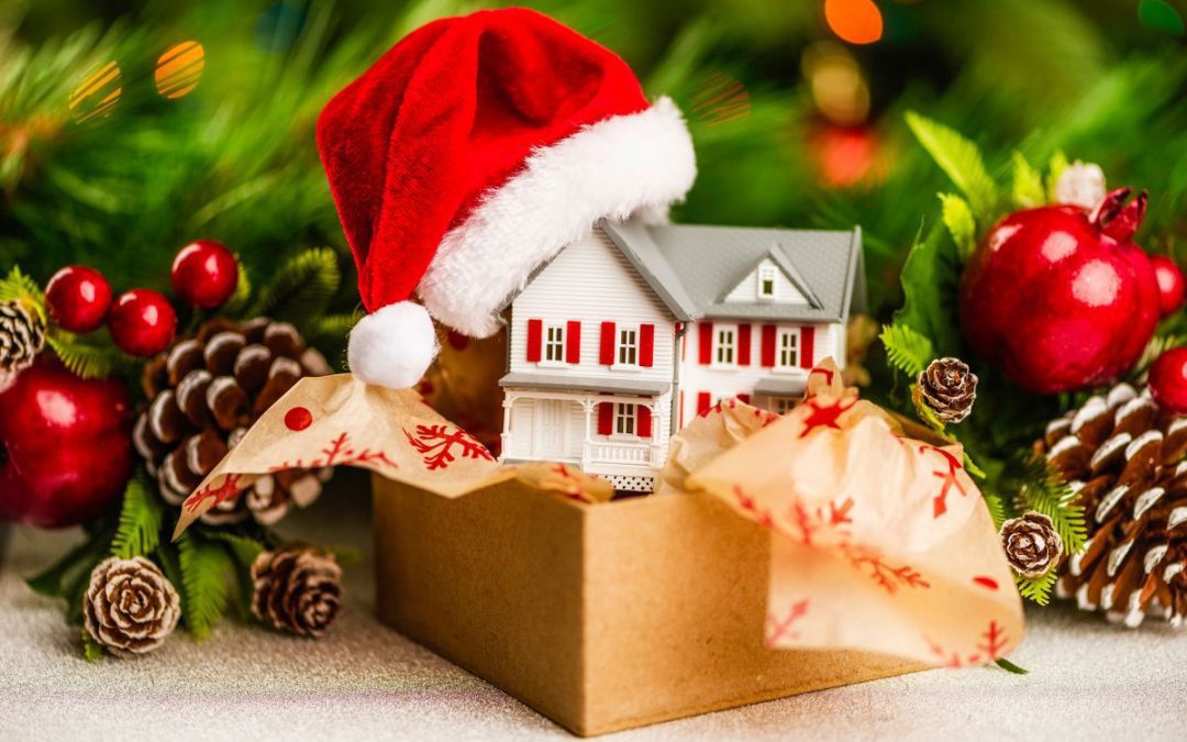 Christmas decorations in a cardboard storage box in front of a Christmas garland