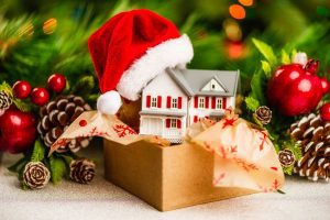 Christmas decorations in a cardboard storage box in front of a Christmas garland