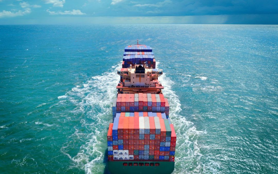 A fully laden container ship heading out on the open ocean