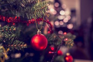 A Christmas Tree with lights, tinsel and a red bauble