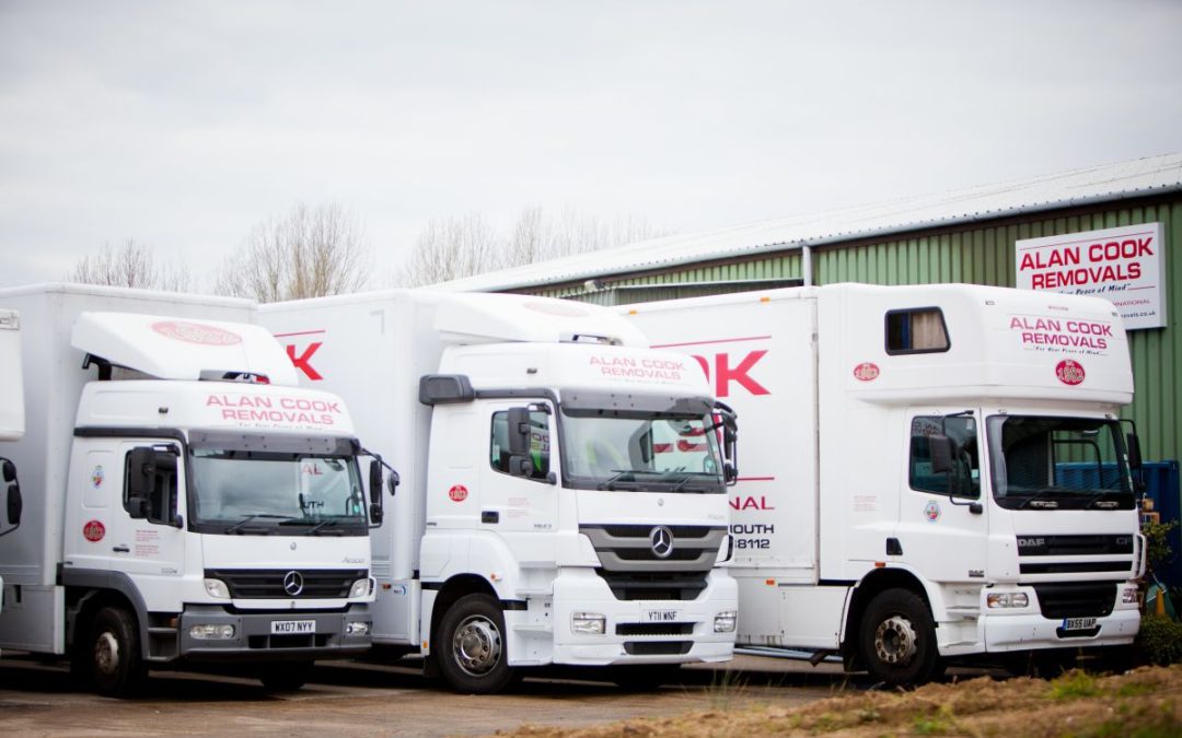 A row of Alan Cook Removals specialist removal lorries in front of the Loddon storage facility