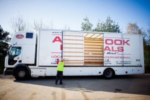 On of our removals team opening the side doors of a lorry to start loading