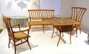 A collection of vintage handcrafted wooden chairs and table