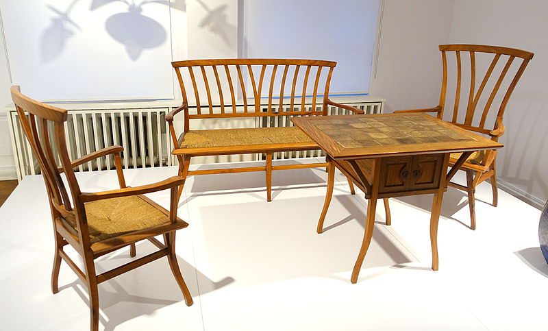 A collection of vintage handcrafted wooden chairs and table