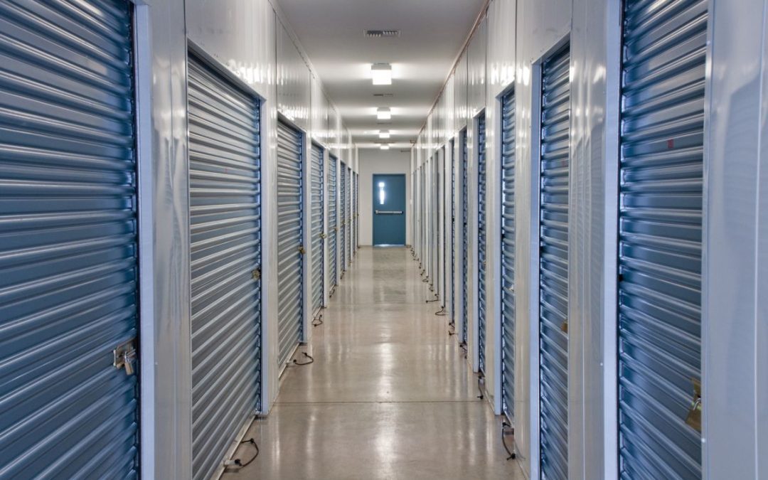 A view looking down the corridor of secure roller shutter doors in an internal self storage facility