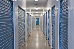 A view looking down the corridor of secure roller shutter doors in an internal self storage facility