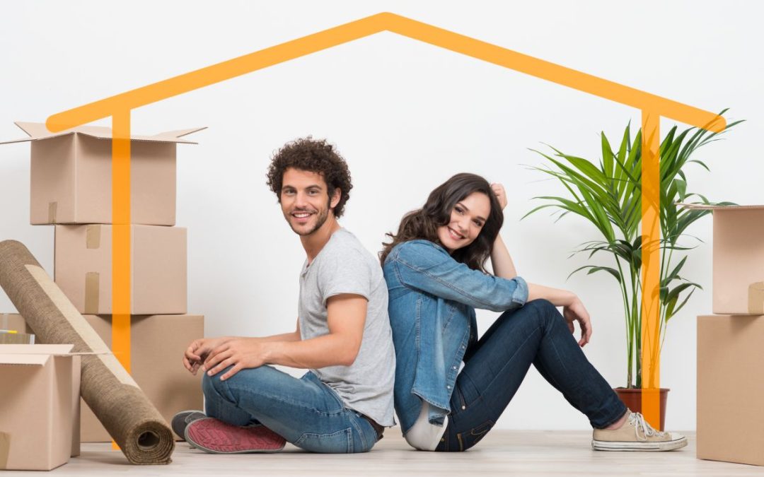 A happy couple sitting on the floor back to back surrounded by cardboard packing boxes, house plant, rug and a house shaped line sitting over them