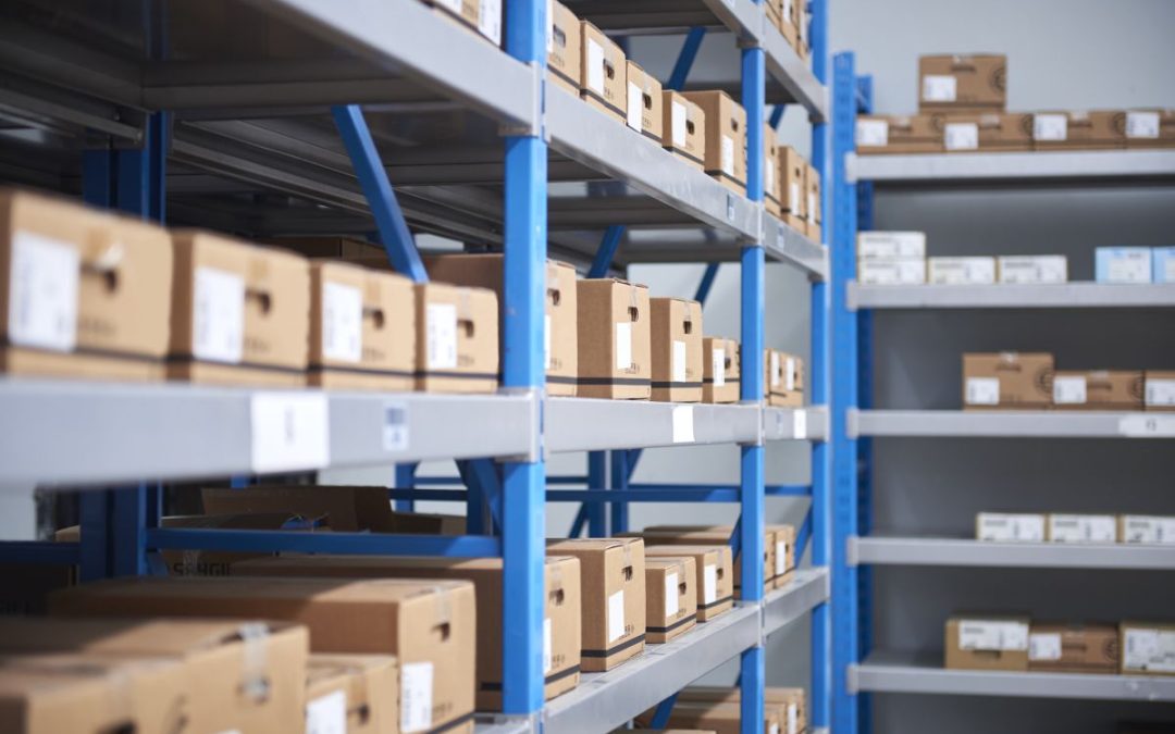 Warehouse metal shelving with lots of neatly labelled and positioned cardboard boxes