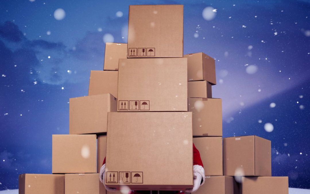 A scene of Father Christmas mostly hidden from view from piles of cardboard packing boxes