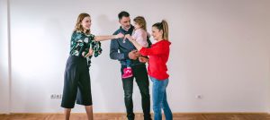 An estate agent handing over keys to a family for their new home