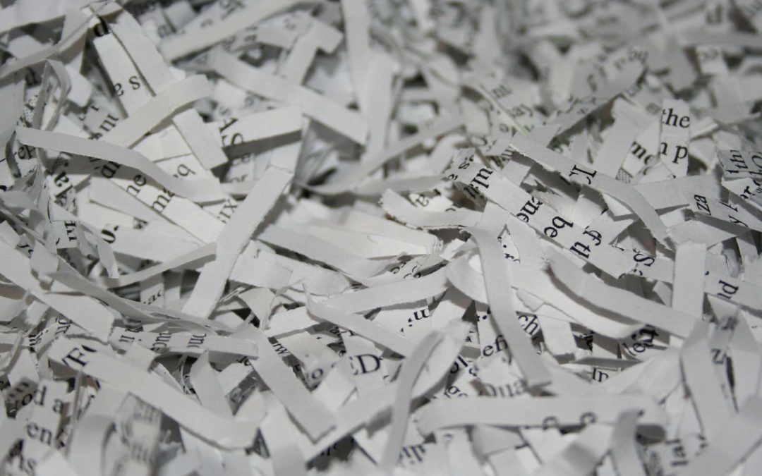 A pile of securely cross cut shredded document paper