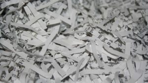 A pile of securely cross cut shredded document paper