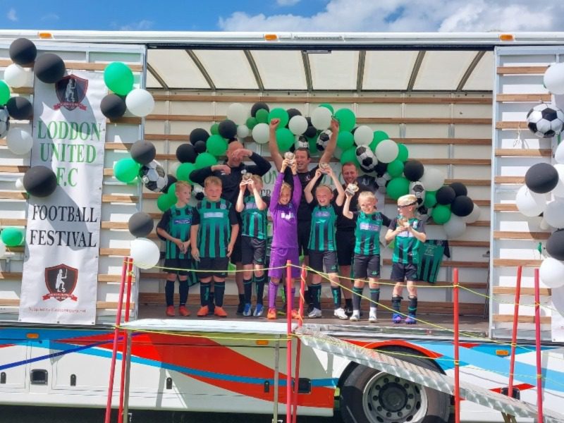 Loddon youth football team celebrating on one of our removals lorries