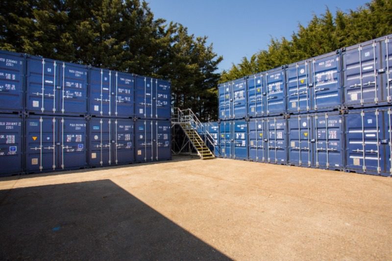 Outdoor secure containerised storage units with movable access platform