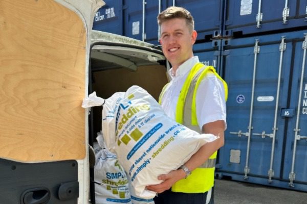 Image illustrating document shredding services, showcasing a shredder in action to ensure secure disposal