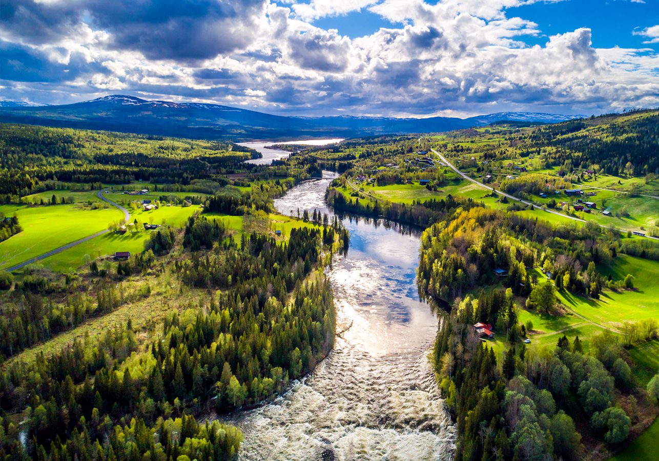 Ristafallet waterfall in Sweden Beautiful landscape view of the Ristafallet waterfall in Sweden with tree lined river and mountain in the background