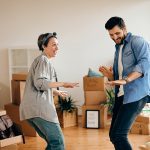 Family moving home with packed boxes, symbolizing a smooth and stress-free relocation process.